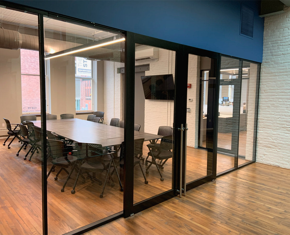NxtWall FLEX glass conference room with double sliding aluminum-frame doors