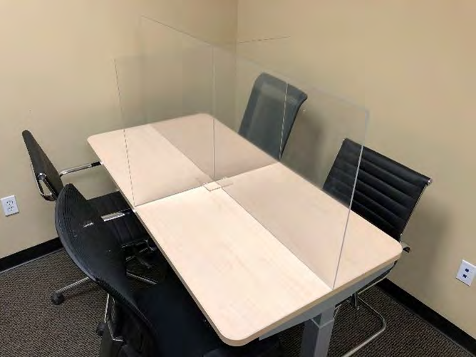 OBEX clear acrylic separation screens on a rectangular meeting table