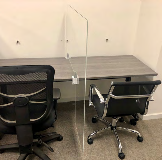 OBEX clear acrylic workstation separation screen clamped to a shared desk